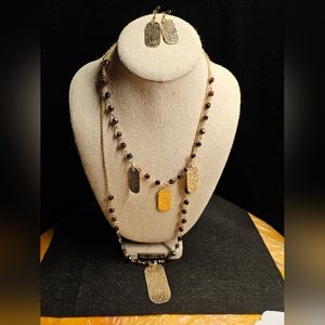 Handmade by me. Beaded garnet stone and hammered gold tone accents.